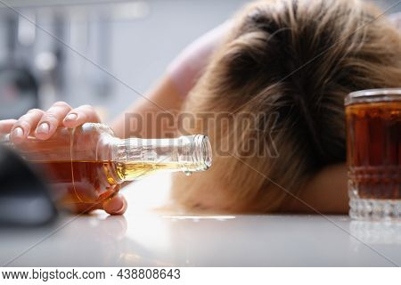 Upset Drunk Woman With A Bottle Of Alcoholic Beverage, Close-up. Long-term Alcohol Dependence. Indec