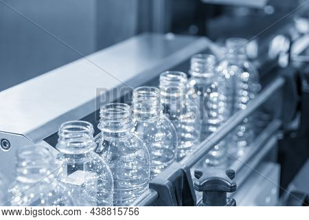 The Empty Pet Bottles  On The Conveyor Belt For Filling Process In The Drinking Water Factory. The H