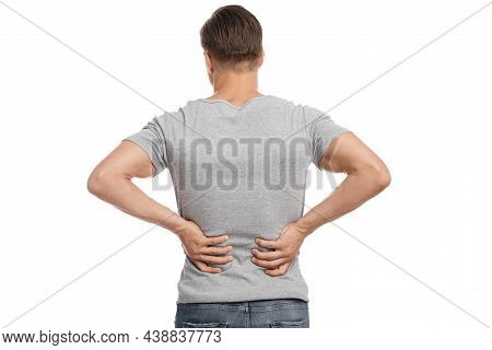 Millennial Caucasian Attractive Guy Presses His Hands To Sore Spot And Suffers From Kidney Or Back P