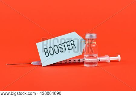 Concept For Corina Virus Booster Vaccination With Vial And Syringe On Red Background