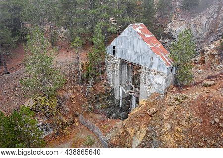 Abandoned Chromite Mine In Troodos Mountains, Cyprus. Old Broken Lift Over Vertical Shaft Surrounded