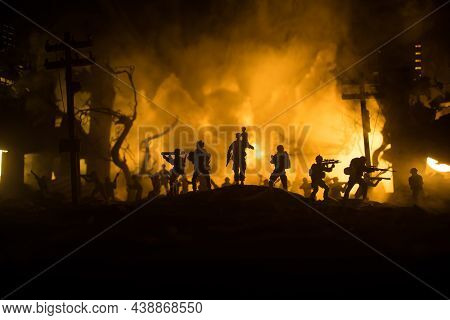 Silhouette Of A Man Carrying Injured Girl From Fire. Rescue Savior Concept. Military Officer Running