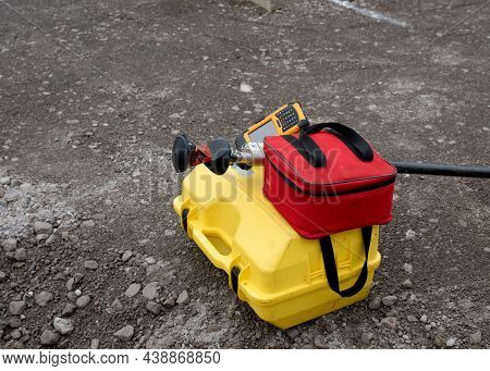 Pogo With Prism And Controller On Top Of Box With Robotic Total Station, And Red Soft Bag For Prism 