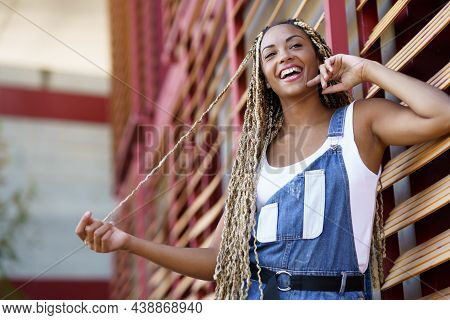 Happy Black Woman With Coloured Braids. Typical African Hairstyle.