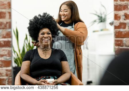 Hairstylist giving a haircut to a customer at a beauty salon