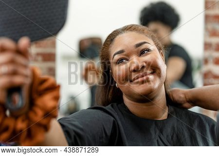 Woman checking her new hairstyle in a mirror