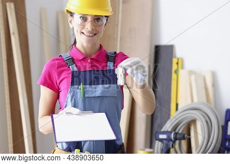 Portrait Of Smiling Female Builder Holding Bunch Of Keys And Documents In Hands. Young Repairer Look