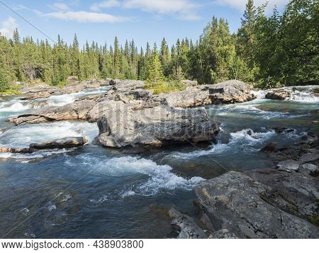 Beautiful Northern Landscape With Rapids And Cascades Of Wild River Kamajokk, Boulders And Spruce Tr