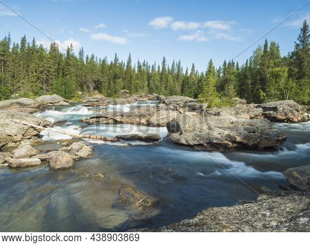 Beautiful Landscape With Long Exposure Water Stream And Cascade Of River Kamajokk, Boulders And Spru