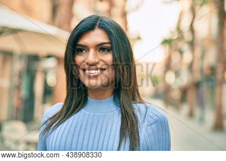 Beautiful hispanic woman smiling confient at the city