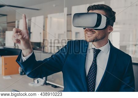 Young Financier Experiencing Immersive Virtual Reality Technology Wearing Vr Glasses, Interacting Wi