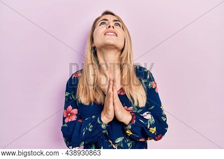 Young caucasian woman wearing casual clothes begging and praying with hands together with hope expression on face very emotional and worried. begging. 