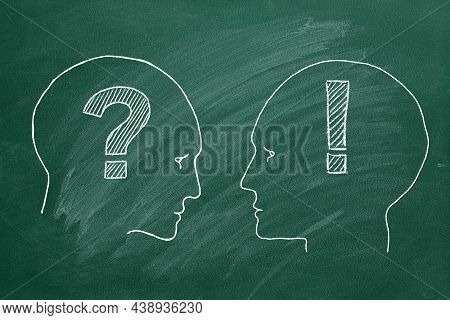 Chalk Illustration On Greenboard. Two Male Heads Face To Face With With Question And Exclamation Mar