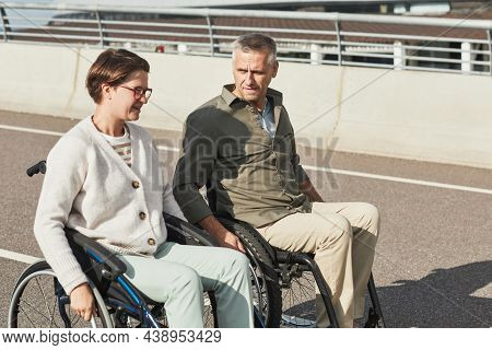 Portrait Of Mature Couple In Wheelchairs Chatting Outdoors And Enjoying City Life, Copy Space