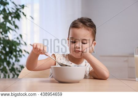 Cute Little Girl Refusing To Eat Her Breakfast At Home