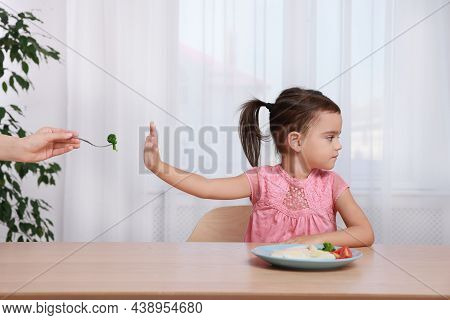 Cute Little Girl Refusing To Eat Her Breakfast At Home