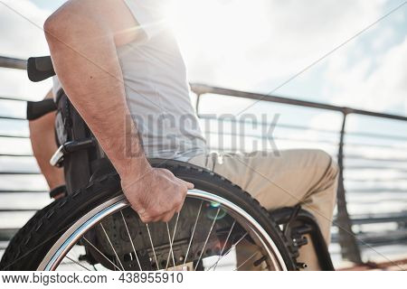 Side View Close Up Of Unrecognizable Adult Man In Wheelchair Outdoors Lit By Sunlight, Copy Space