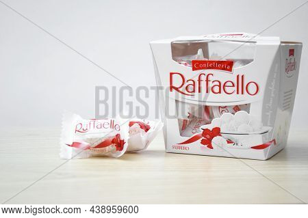 Raffaello Sweets On A Light Wooden Table And White Background.