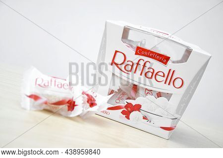 Raffaello Sweets On A Light Wooden Table And White Background.