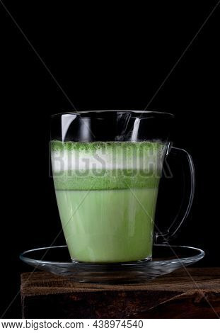 Matcha Latte On Plant-based Milk In Glass Cup Against The Black Background. Hot Healthy Vegan Drink