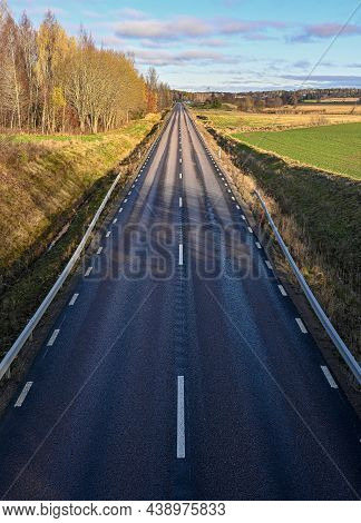 Straight Highroad With Wet And Dry Tarmac