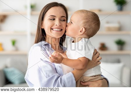 Mother Child Love. Cute Little Baby Boy Kissing Happy Mom At Home