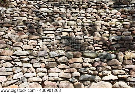 Sunny Spring Day. On A Slope Of The Hill From A Natural Stone Several Retaining Walls Are Put.