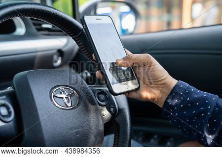 Bangkok, Thailand, July 1, 2020 Holding Iphone In Toyota Sienta Car To Communication With Family And