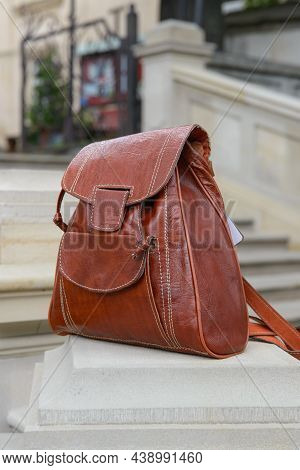 Orange Leather Backpack On The Snone Monument
