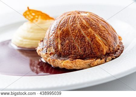 Tenderloin with pork, mushrooms and sirloin puff pastry on a white background. Homemade meal for wellington.