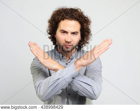 emotion and people concept: young man making time out gesture over white backgound