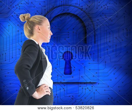 Composite image of blonde businesswoman standing with hands on hips
