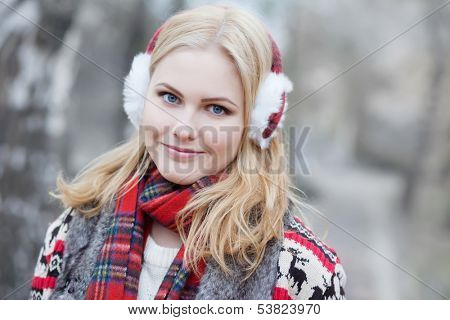 Pretty blonde girl in fur headphones