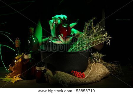  Witch in scary Halloween laboratory on dark color background