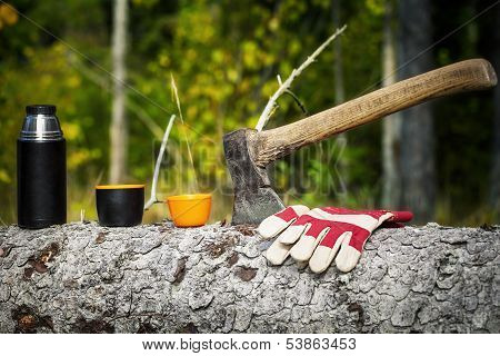 Ax with plastic cups in forest