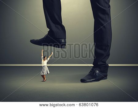 joyful woman under big mans legs over dark background
