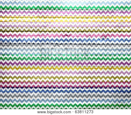Colorful chevron pattern on wood texture background