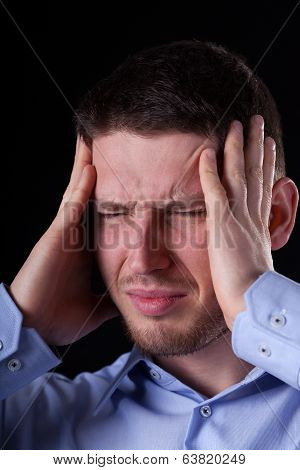 Man Holding Head In Pain