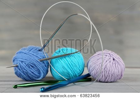 Balls of wool on wooden table background