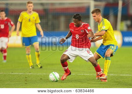 VIENNA,  AUSTRIA - JUNE  7 Alexander Kacaniklic (#19 Sweden) and David Alaba (#8 Austria) fight for the ball during the world cup qualifier game on June 7, 2013 in Vienna, Austria.