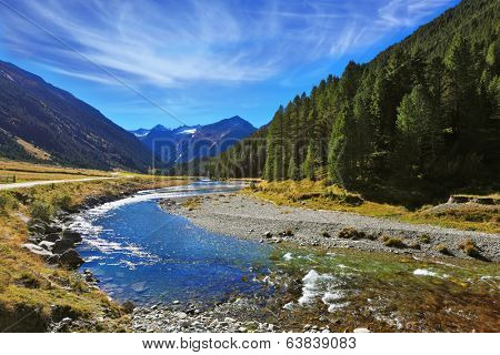 Austrian Alps. Headwaters of the famous Krimml waterfalls. The crystal clear transparent water glows in the midday sun