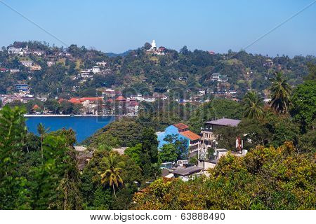 KANDY, SRI LANKA - FEBRUARY 26, 2014: View on Kandy lake and city buildings. Kandy is home of The Temple of the Tooth Relic, one of the most sacred Buddhist places of worship.