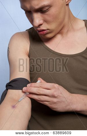 Drug addict man with syringe in action