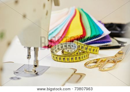 Tailor or sewing set. Cloth, machine, scissors, measure tape