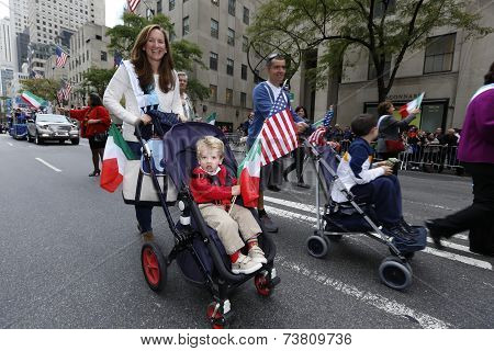 Little parade goer in stroller with US flag