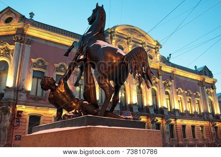 ST. PETERSBURG, RUSSIA - JANUARY 17, 2013: Sculpture at the Anichkov Bridge against Belosselsky-Belozersky Palace. The palace is under restoration till October 2013 after the fire of February 28, 2012