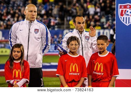 HARTFORD - OCTOBER 10: Brad Guzan and Landon Donovan with kids on stadium before socce match between US Men`s National Team vs Ecuador, on October 10, 2014, in Rentschler Field stadium, Hartford, USA.