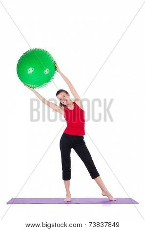 Young woman exercising with swiss ball