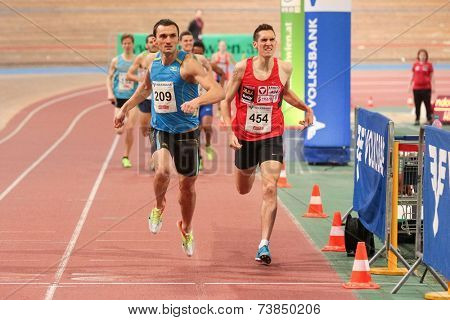 VIENNA, AUSTRIA - JANUARY 28, 2014: Ioan Zaizan (#209 Romania) wins the men's 1500m event in an indoor track and field meeting.