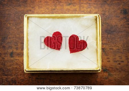 Two hearts inside a golden gift box. Gift of love. hearty gift. 